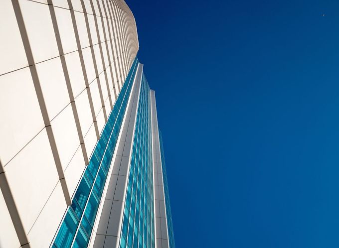View up the side of the InterContinental Hotel, with a cloudless blue sky, in the South of Market (SOMA) neighborhood of San Francisco, California, 2016.